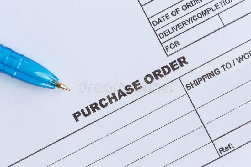 Purchase order with blue pen in the officeâ€